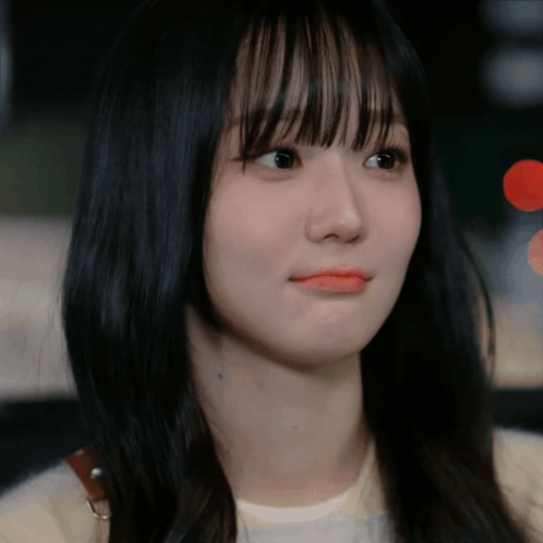 A Close Up Of A Woman 'S Face With Long Black Hair GIF