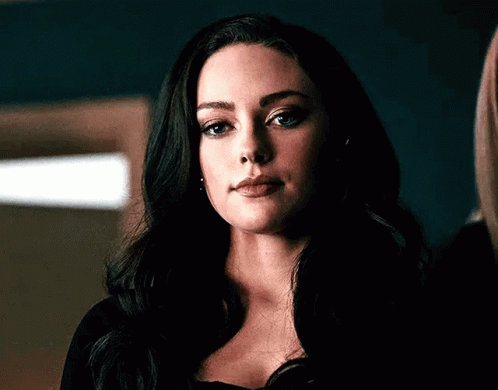 A Close Up Of A Woman 'S Face With Long Black Hair . GIF