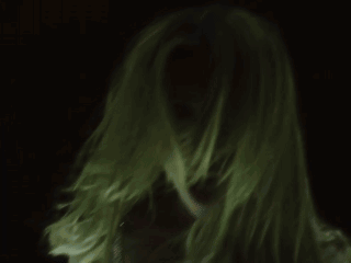 A Close Up Of A Woman 'S Face With Long Blonde Hair GIF