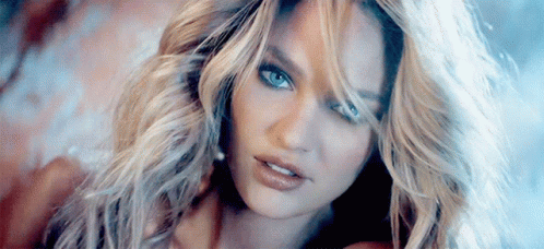 A Close Up Of A Woman 'S Face With Long Blonde Hair GIF