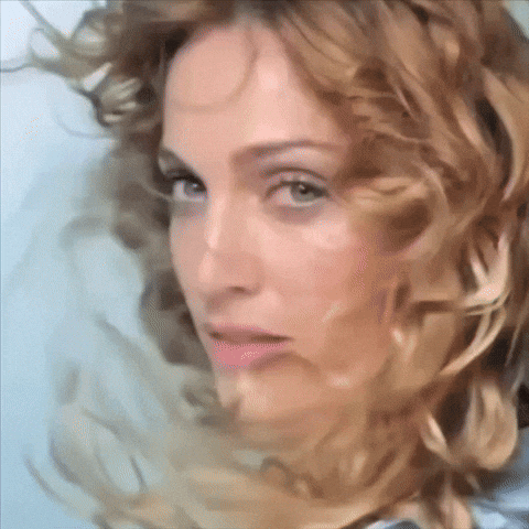 A Close Up Of A Woman 'S Face With Long Blonde Hair GIF