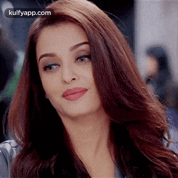 A Close Up Of A Woman 'S Face With Long Brown Hair And Red Lips . GIF