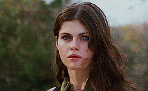 A Close Up Of A Woman 'S Face With Long Brown Hair GIF