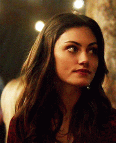 A Close Up Of A Woman 'S Face With Long Dark Hair GIF