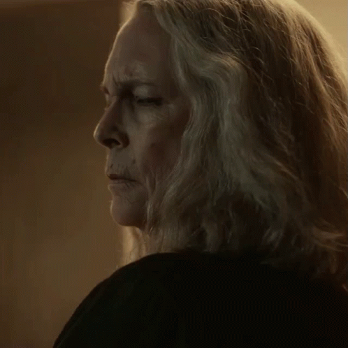A Close Up Of A Woman 'S Face With Long Grey Hair GIF