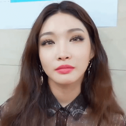 A Close Up Of A Woman 'S Face With Long Hair GIF