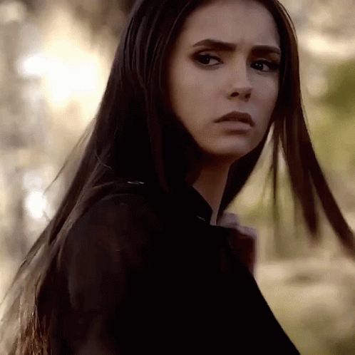 A Close Up Of A Woman 'S Face With Long Hair . GIF