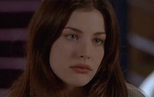 A Close Up Of A Woman 'S Face With Long Hair GIF
