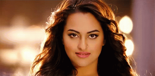 A Close Up Of A Woman 'S Face With Long Hair And A Serious Look On Her Face . GIF