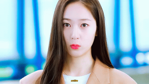 A Close Up Of A Woman 'S Face With Long Hair And Red Lips GIF