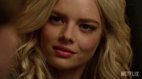 A Close Up Of A Woman 'S Face With Netflix Written On The Bottom GIF