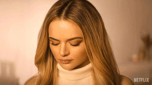 A Close Up Of A Woman 'S Face With Netflix Written On The Bottom GIF