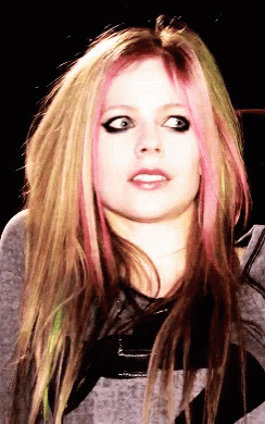 A Close Up Of A Woman 'S Face With Pink Hair GIF