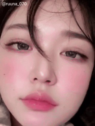 A Close Up Of A Woman 'S Face With Pink Lips GIF