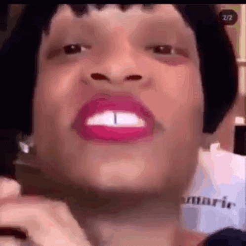 A Close Up Of A Woman 'S Face With Pink Lipstick And A Very Large Mouth . GIF