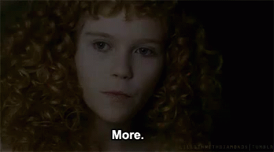 A Close Up Of A Woman 'S Face With Red Curly Hair And The Words `` More '' . GIF
