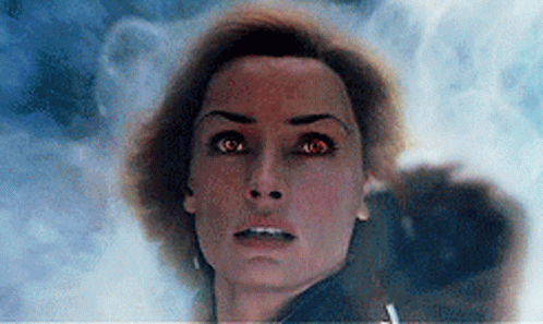 A Close Up Of A Woman 'S Face With Red Eyes Looking At The Camera GIF