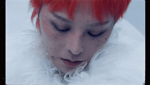 A Close Up Of A Woman 'S Face With Red Hair GIF