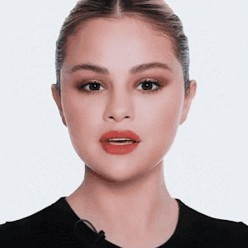 A Close Up Of A Woman 'S Face With Red Lips And A Microphone . GIF