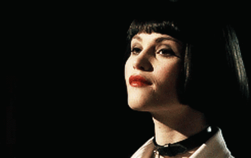 A Close Up Of A Woman 'S Face With Red Lips GIF