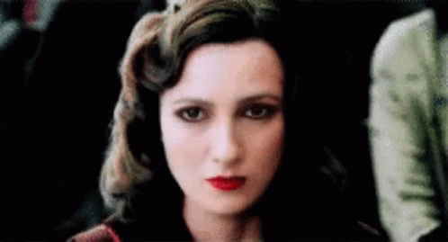 A Close Up Of A Woman 'S Face With Red Lips . GIF