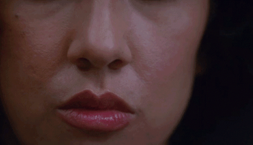 A Close Up Of A Woman 'S Face With Red Lipstick GIF