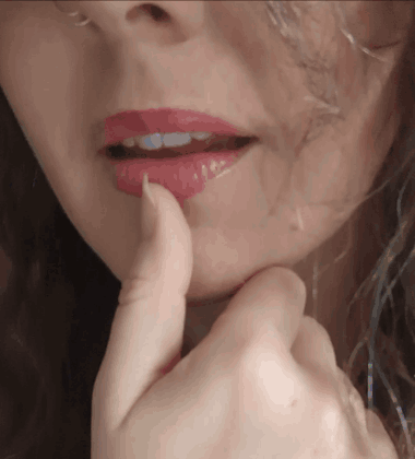 A Close Up Of A Woman 'S Face With Red Lipstick On Her Lips GIF