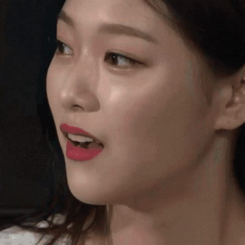A Close Up Of A Woman 'S Face With Red Lipstick On GIF