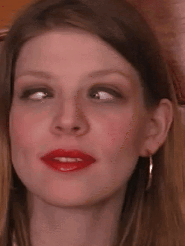 A Close Up Of A Woman 'S Face With Red Lipstick On . GIF