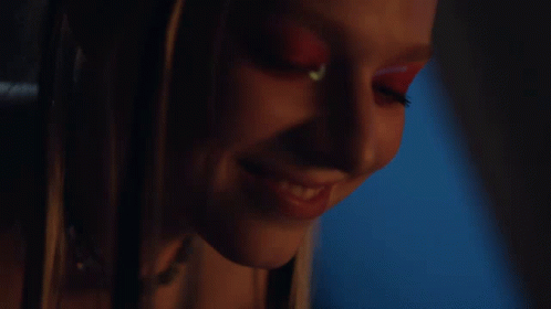 A Close Up Of A Woman 'S Face With Red Makeup GIF