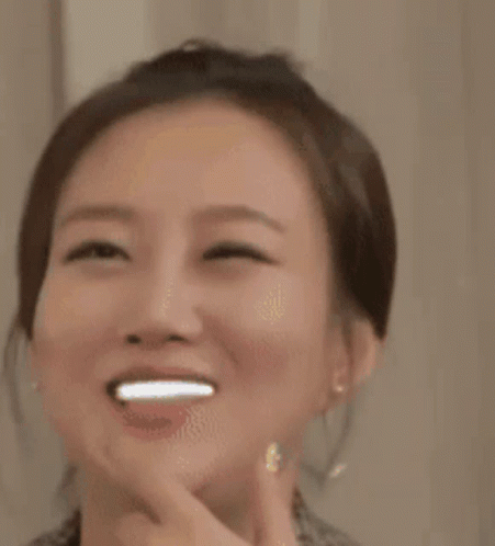 A Close Up Of A Woman 'S Face With Stars On Her Face GIF