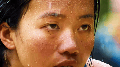 A Close Up Of A Woman 'S Face With Sweat Drops On It GIF