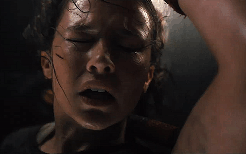 A Close Up Of A Woman 'S Face With Sweat On Her Forehead GIF