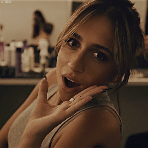 A Close Up Of A Woman 'S Face With Tatestyle Written On The Bottom Left GIF