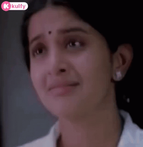 A Close Up Of A Woman 'S Face With Tears Coming Out Of Her Eyes . GIF