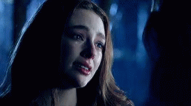 A Close Up Of A Woman 'S Face With Tears Running Down Her Face . GIF