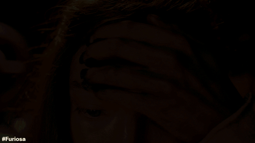 A Close Up Of A Woman 'S Face With The Hashtag Furiosa On The Bottom GIF