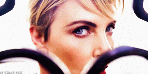 A Close Up Of A Woman 'S Face With The Hashtag Gaytonicblonde GIF