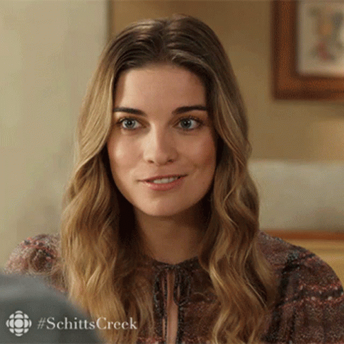 Close Up Of Woman's Face With Schitts Creek Hashtag GIF