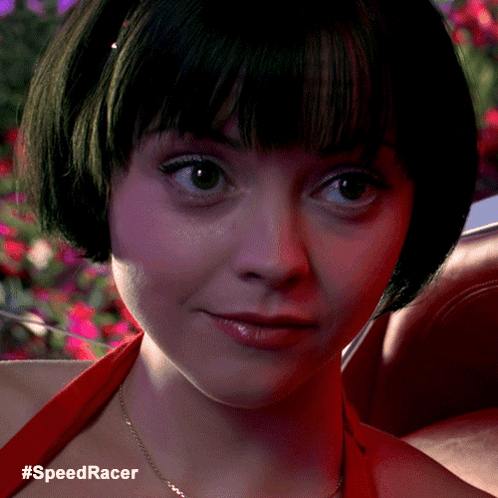 A Close Up Of A Woman 'S Face With The Hashtag #Speedracer Below Her GIF