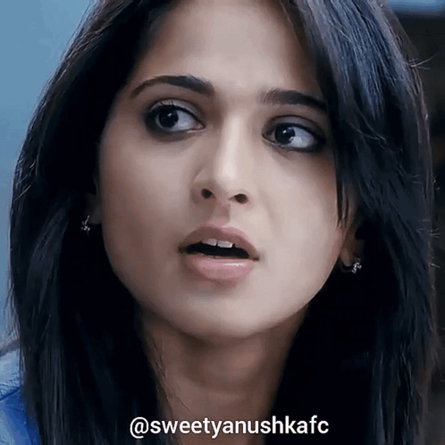 A Close Up Of A Woman 'S Face With The Hashtag Sweetyanushkafc On The Bottom GIF