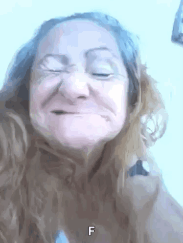 A Close Up Of A Woman 'S Face With The Letter F Visible GIF