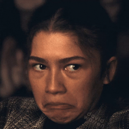 A Close Up Of A Woman 'S Face With The Name David Worren Written On Her Shirt GIF