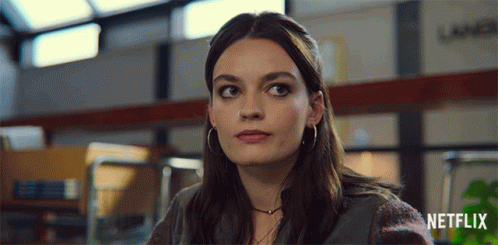 A Close Up Of A Woman 'S Face With The Netflix Logo In The Corner GIF