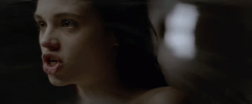 A Close Up Of A Woman 'S Face With The Number 8 In The Background GIF