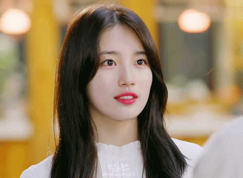 A Close Up Of A Woman 'S Face With The Number 841013 On Her Shirt GIF
