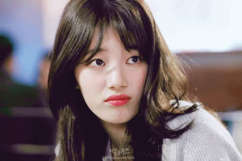 A Close Up Of A Woman 'S Face With The Number 94 1010 On The Bottom GIF