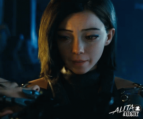 A Close Up Of A Woman 'S Face With The Word Alita On The Bottom Right GIF