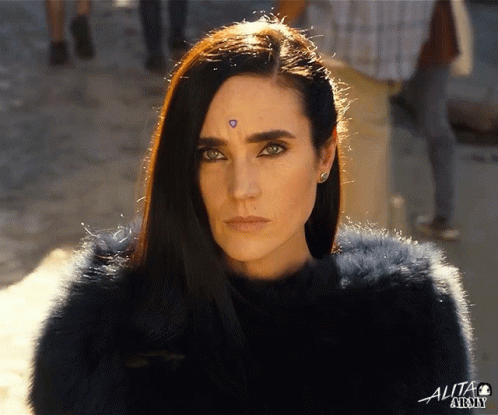 A Close Up Of A Woman 'S Face With The Word Alta On The Bottom Left GIF