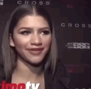 A Close Up Of A Woman 'S Face With The Word Cross On The Bottom GIF